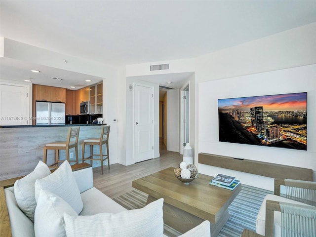 living room with light hardwood / wood-style flooring