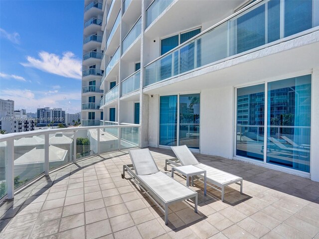 view of patio featuring a balcony