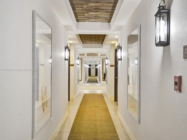 corridor featuring a raised ceiling