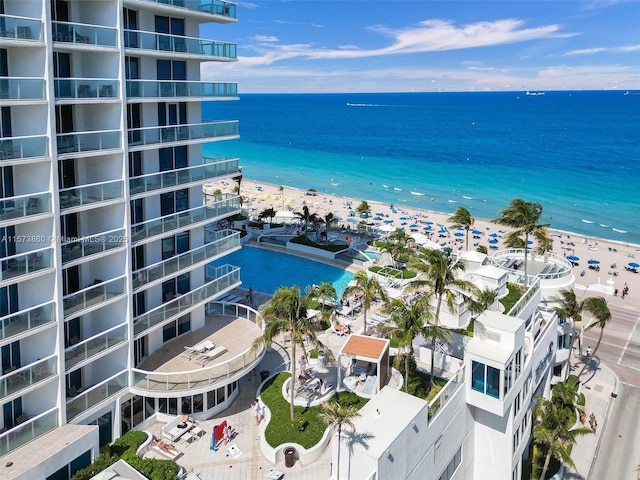 birds eye view of property featuring a beach view and a water view