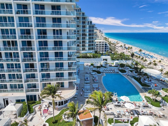 bird's eye view with a water view and a beach view