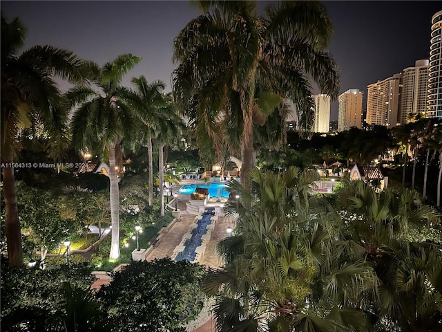 view of pool at twilight