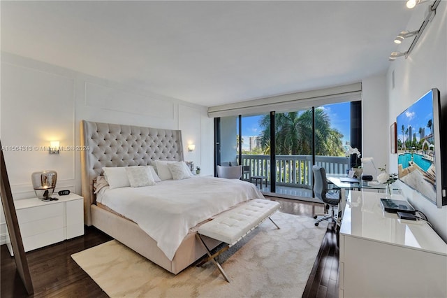 bedroom featuring access to outside and dark hardwood / wood-style floors