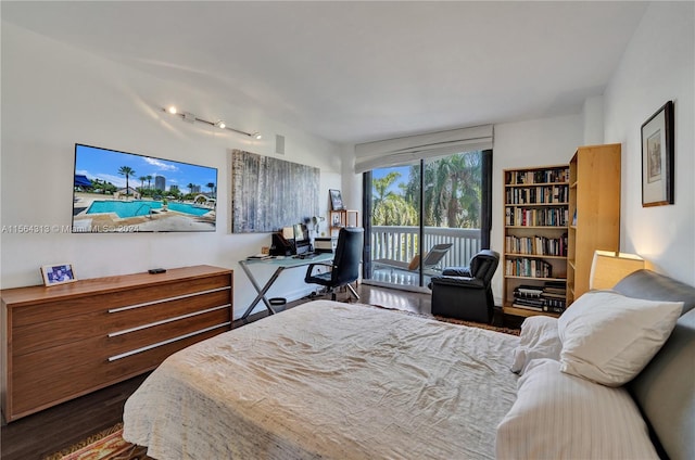 bedroom with wood-type flooring and access to exterior