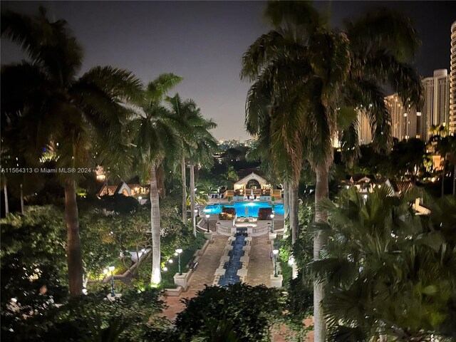 view of pool at twilight