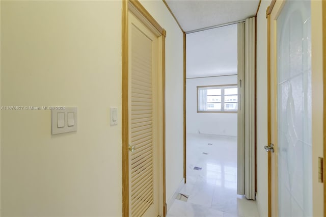 hallway featuring light tile flooring