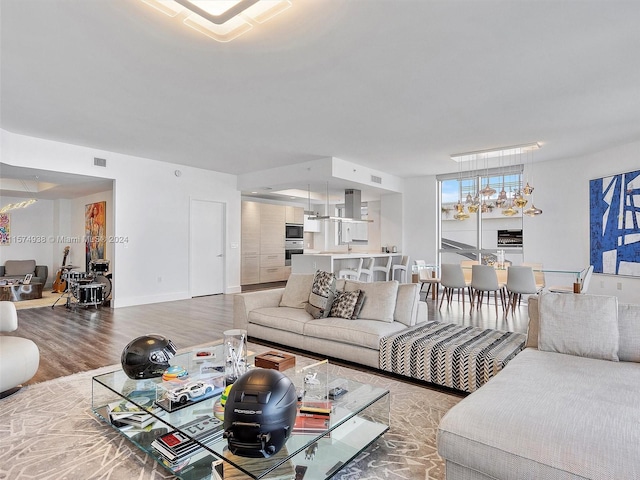 living room with a notable chandelier and hardwood / wood-style flooring