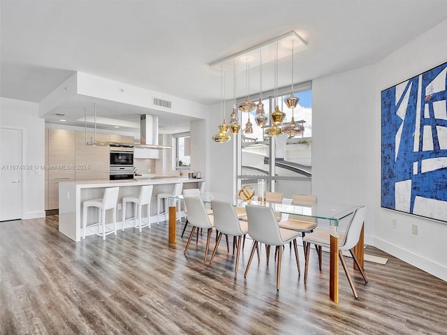 dining space featuring an inviting chandelier and hardwood / wood-style floors