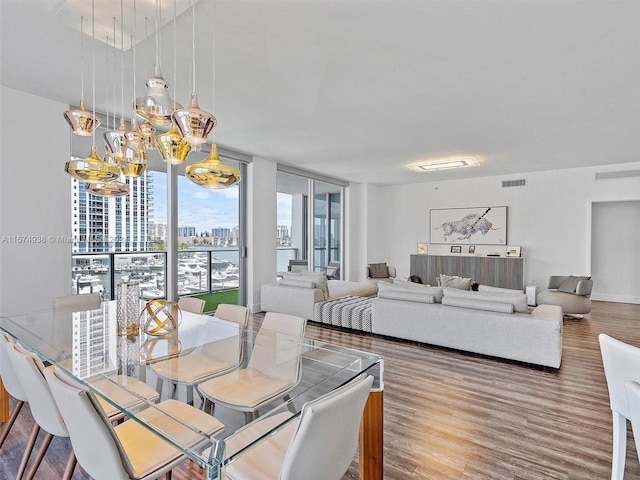 dining area featuring expansive windows and hardwood / wood-style flooring