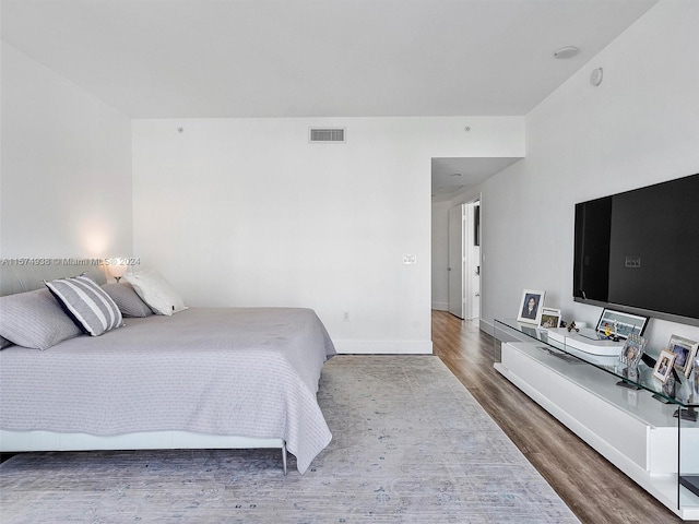 bedroom with wood-type flooring