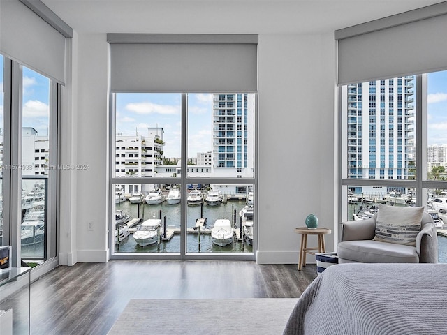 bedroom featuring a wall of windows and hardwood / wood-style flooring