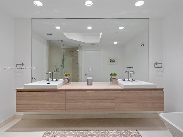 bathroom with double sink vanity, tile patterned flooring, and independent shower and bath