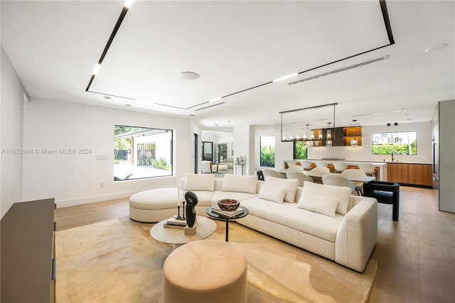 living room with sink and light hardwood / wood-style floors