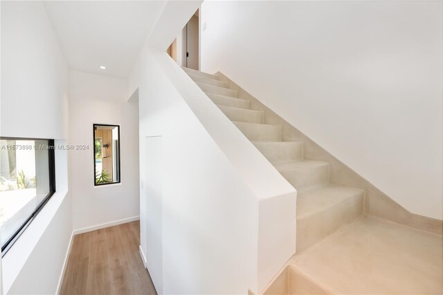 stairs featuring light wood-type flooring