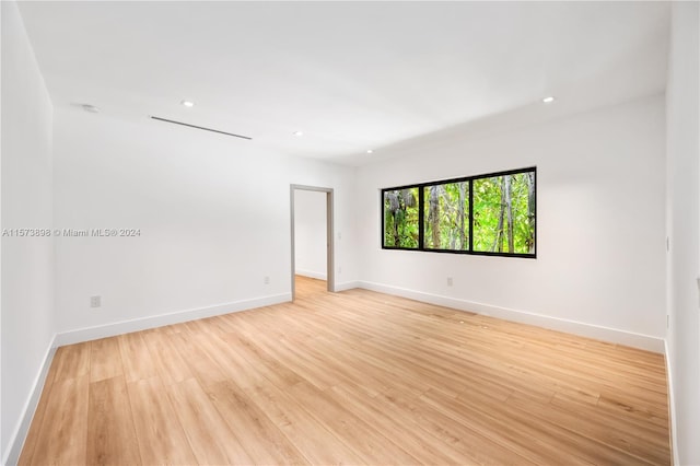 unfurnished room with light wood-type flooring