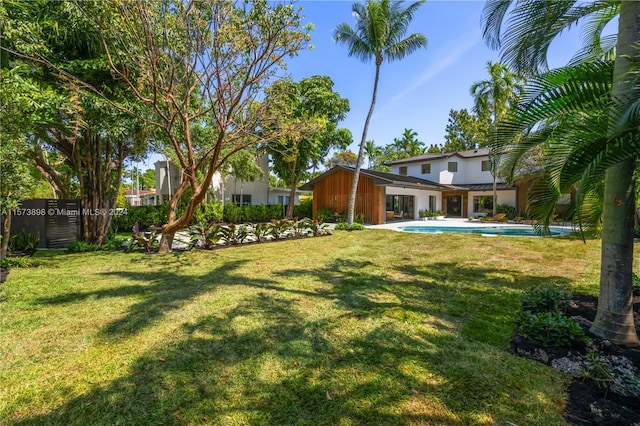 view of yard with a fenced in pool