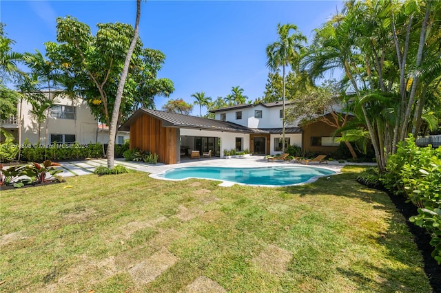 view of pool featuring a patio and a lawn