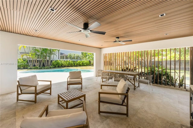 view of patio / terrace featuring an outdoor living space, ceiling fan, and a fenced in pool