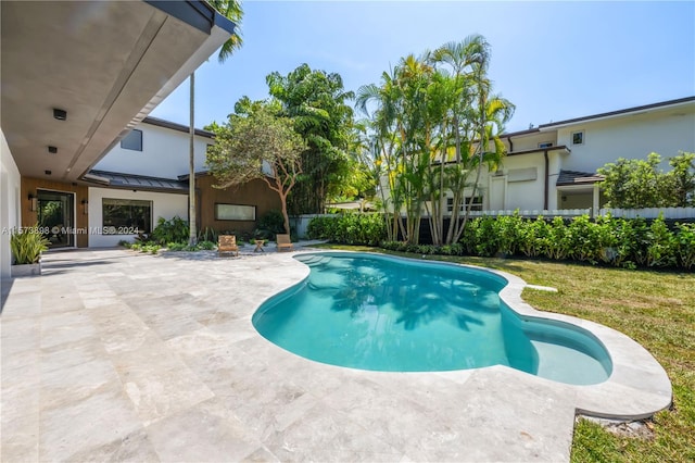 view of pool with a yard and a patio