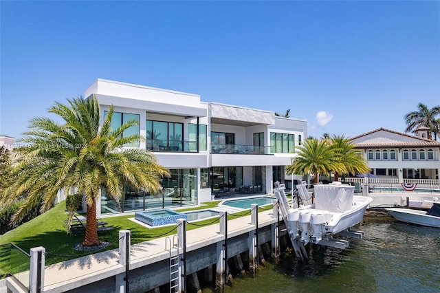 back of house with a water view and a balcony