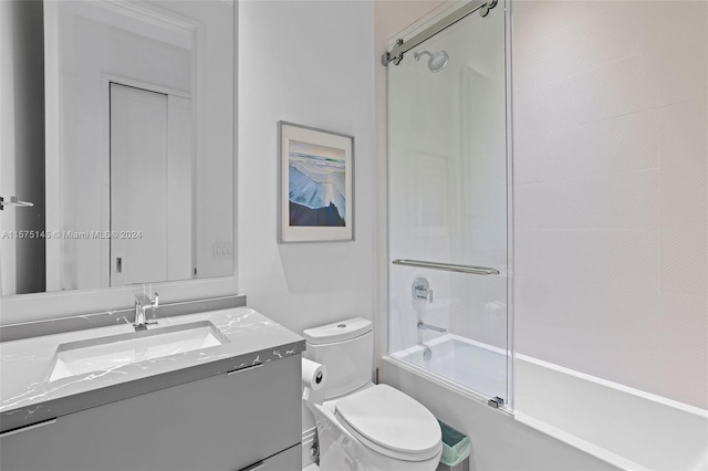 full bathroom with vanity, toilet, and combined bath / shower with glass door