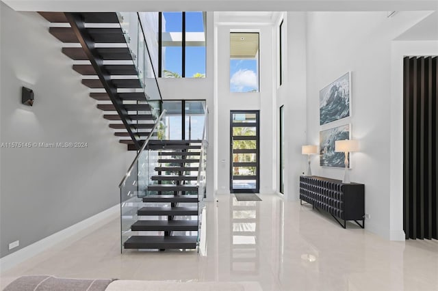 interior space featuring tile floors and a high ceiling