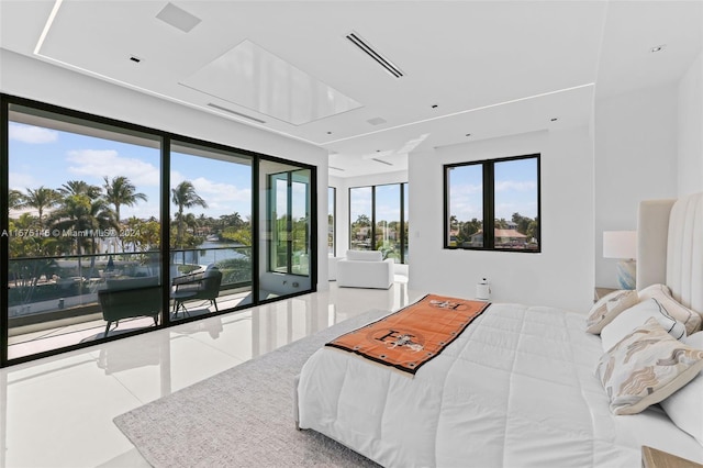 bedroom with a water view, tile floors, and access to outside