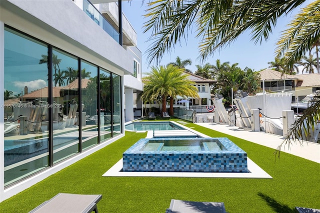 exterior space featuring a patio and a pool with hot tub