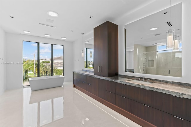 bathroom with a shower with door, plenty of natural light, and tile floors