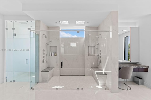 bathroom featuring a wealth of natural light, an enclosed shower, and tile floors