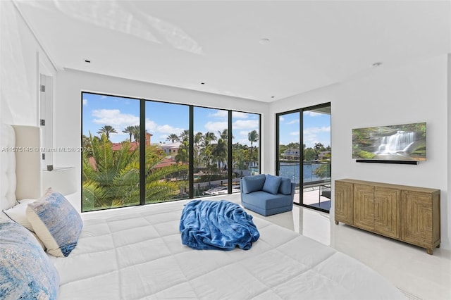 bedroom with a water view and access to outside