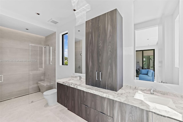 bathroom featuring vanity with extensive cabinet space, an enclosed shower, tile flooring, dual sinks, and toilet