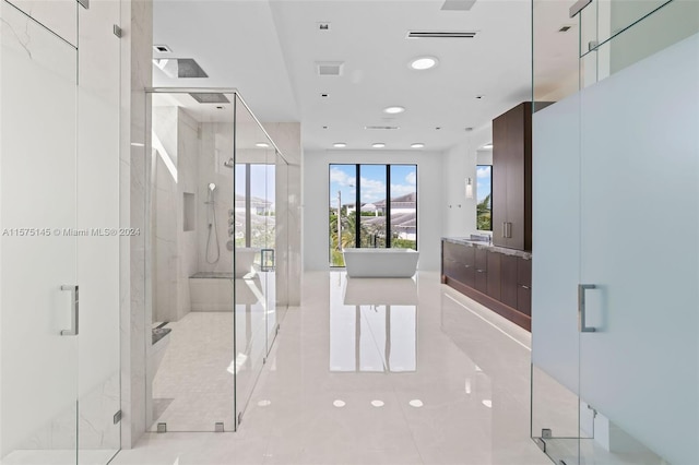 bathroom with vanity with extensive cabinet space, an enclosed shower, and tile flooring