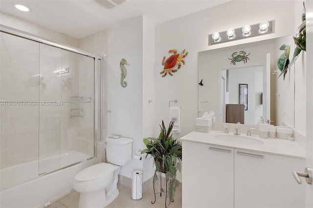 full bathroom with vanity, tile floors, toilet, and enclosed tub / shower combo