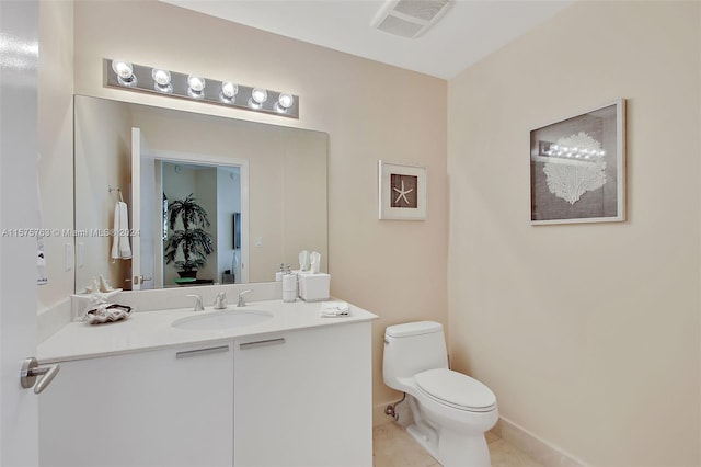 bathroom with large vanity, tile floors, and toilet