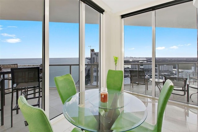 dining room featuring floor to ceiling windows and light tile floors