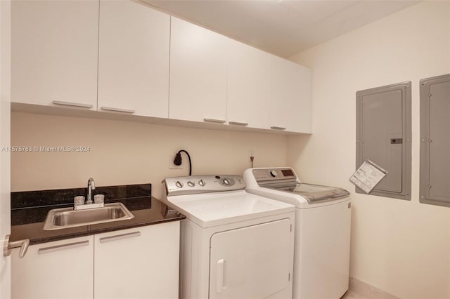 clothes washing area featuring electric dryer hookup, cabinets, sink, and washing machine and clothes dryer