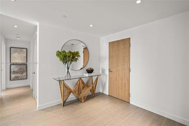 interior space featuring light wood-type flooring, baseboards, and recessed lighting