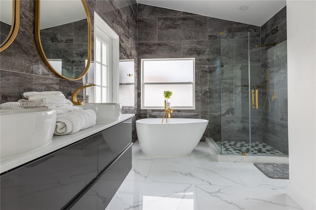 bathroom featuring shower with separate bathtub, a wealth of natural light, tile patterned flooring, and tile walls