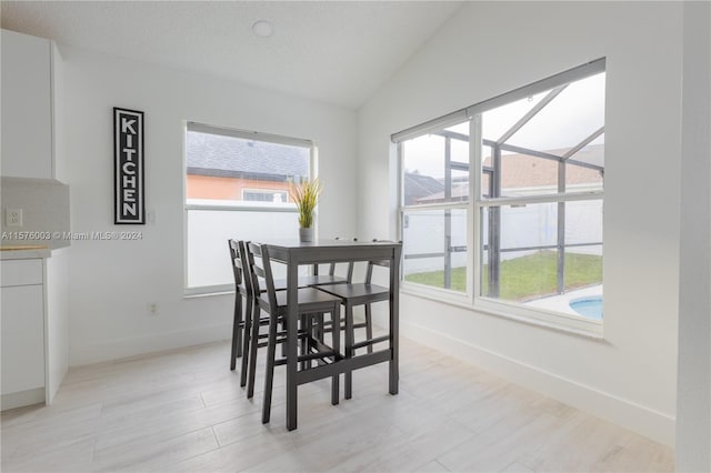 dining space featuring lofted ceiling