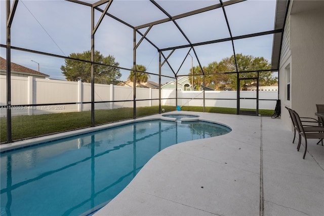 view of pool featuring a yard, a patio area, and a lanai