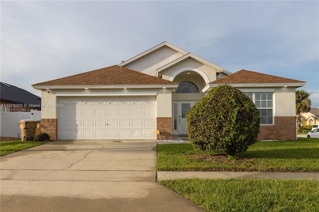 view of front of property with a garage and a front yard