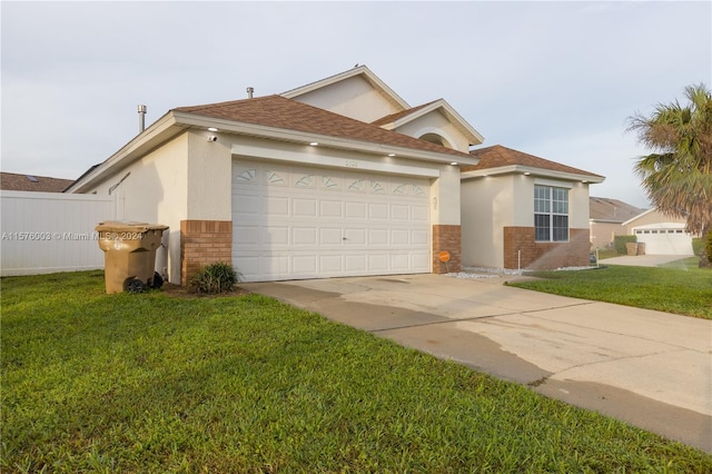 view of front of home featuring a garage and a front yard