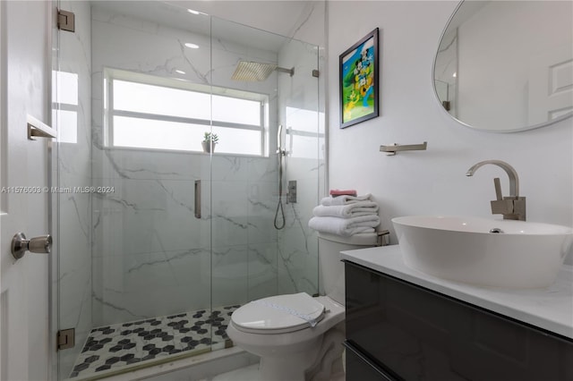 bathroom featuring vanity, an enclosed shower, and toilet