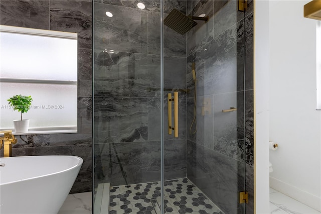 bathroom featuring tile walls, tile patterned floors, and separate shower and tub