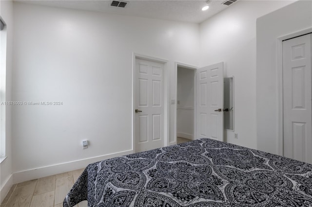 bedroom with a textured ceiling and a closet