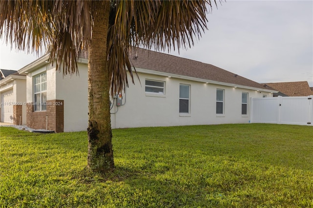 rear view of house featuring a yard