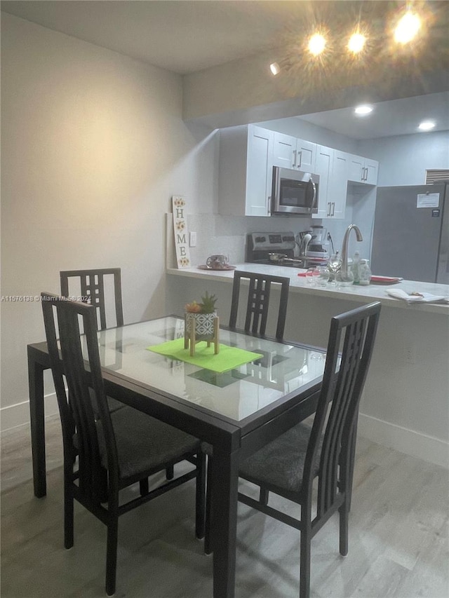 dining area featuring light wood-type flooring