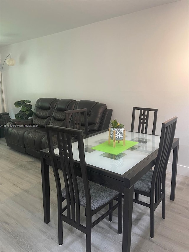 dining space with light hardwood / wood-style floors