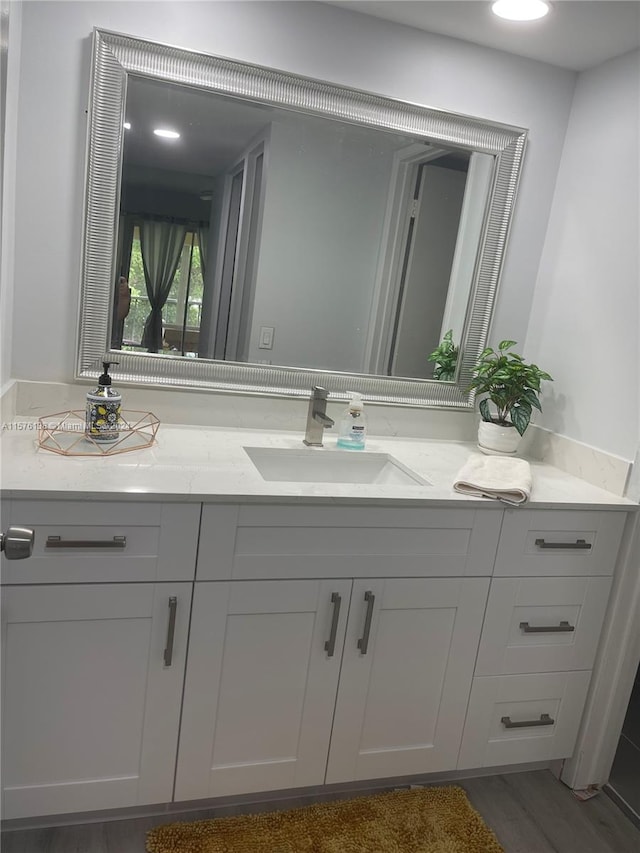 bathroom featuring hardwood / wood-style floors and vanity